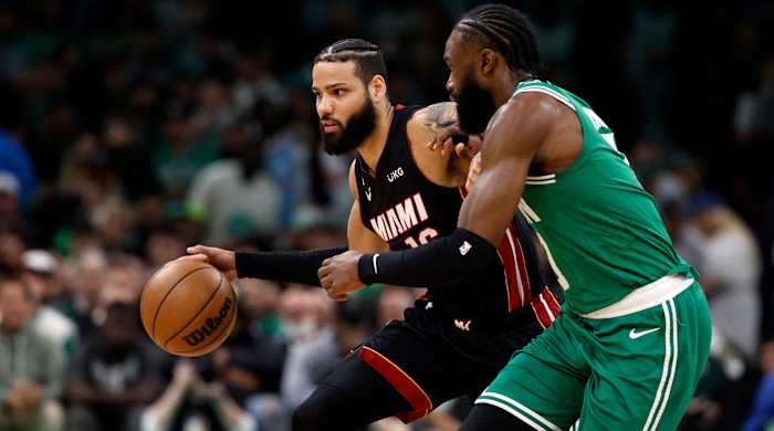 Miami Heat forward Caleb Martin controls the ball against Boston Celtics guard Jaylen Brown.